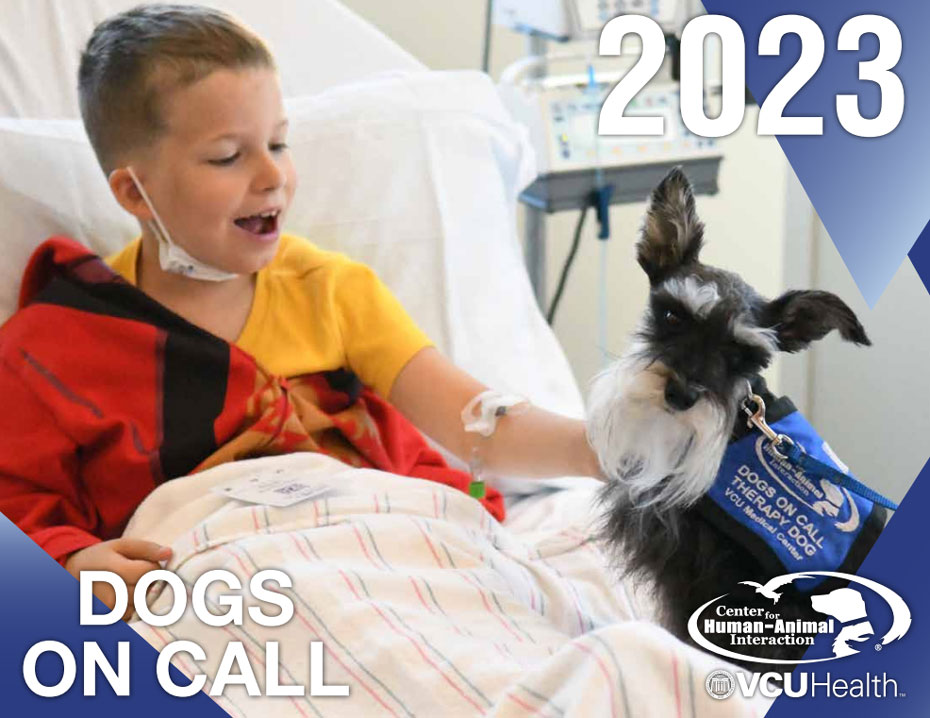 2023 Dogs on Call calendar cover featuring a boy in a hospital bed petting a small dog, the text 2023, DOGS ON CALL, and the VCU CHAI and VCUHealth logos
