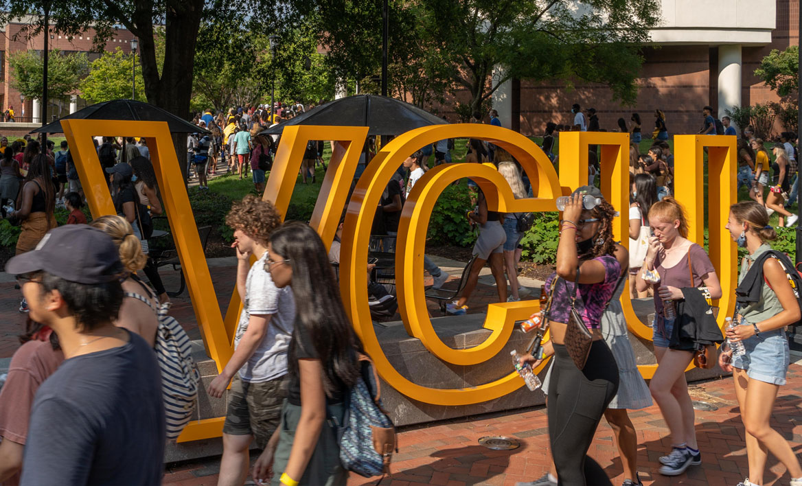 Photo of students in front of campus VCU letters