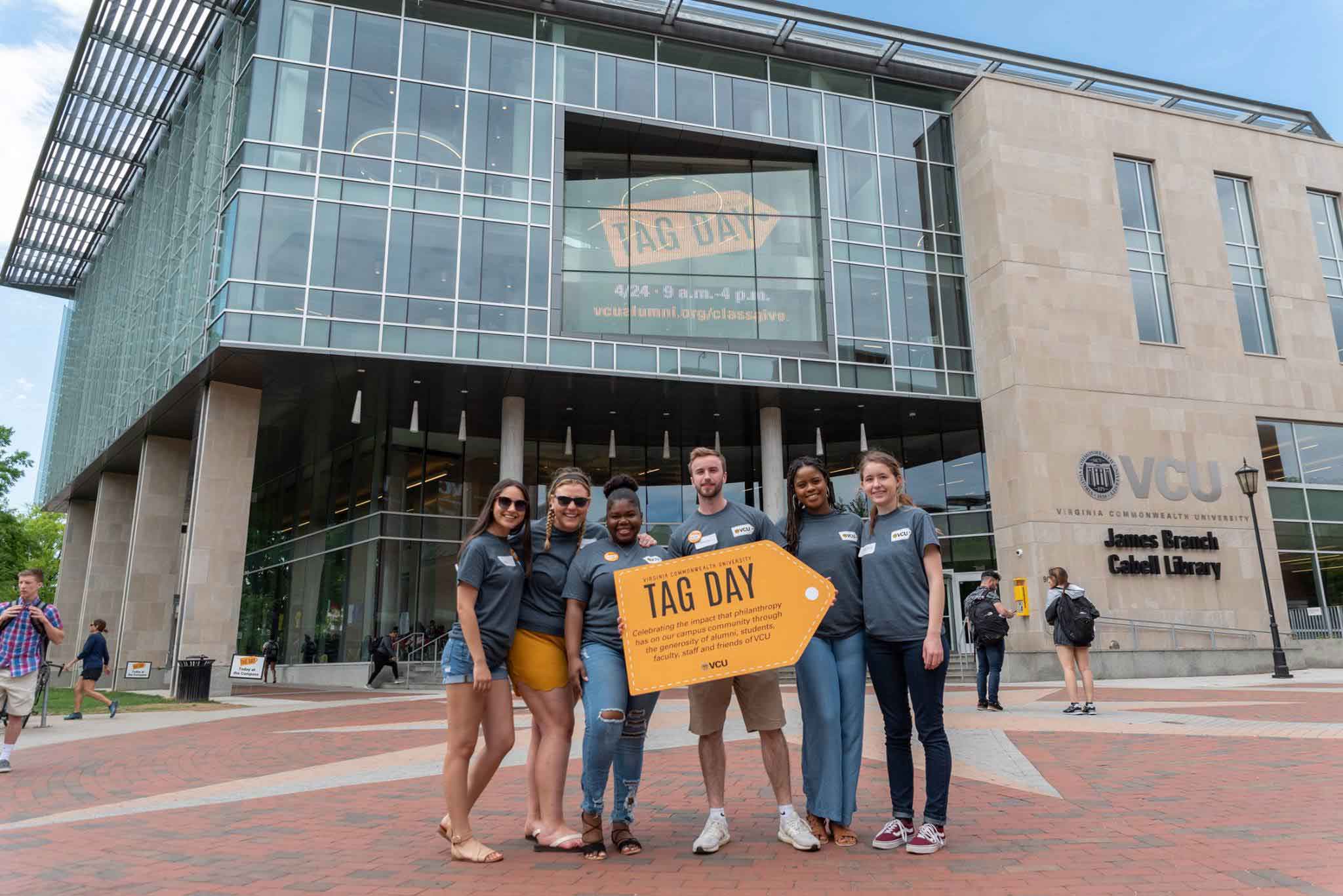 Students in front of Tag Day sign at library