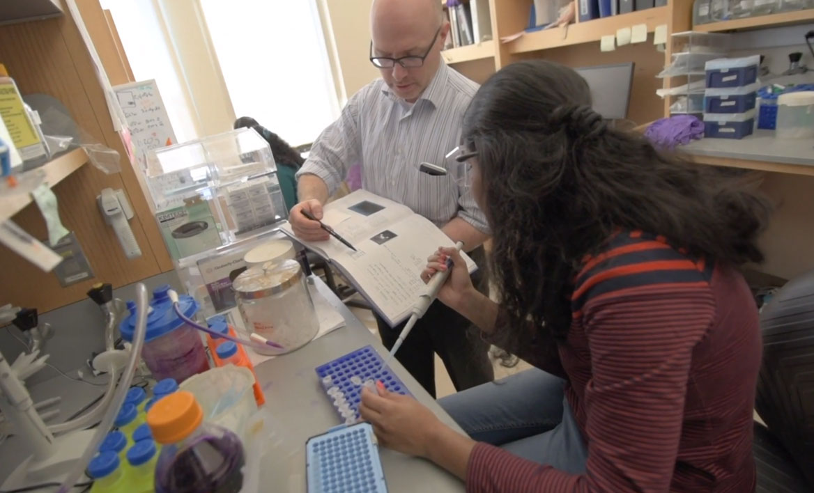 photo of Massey researcher Joseph Landry and student